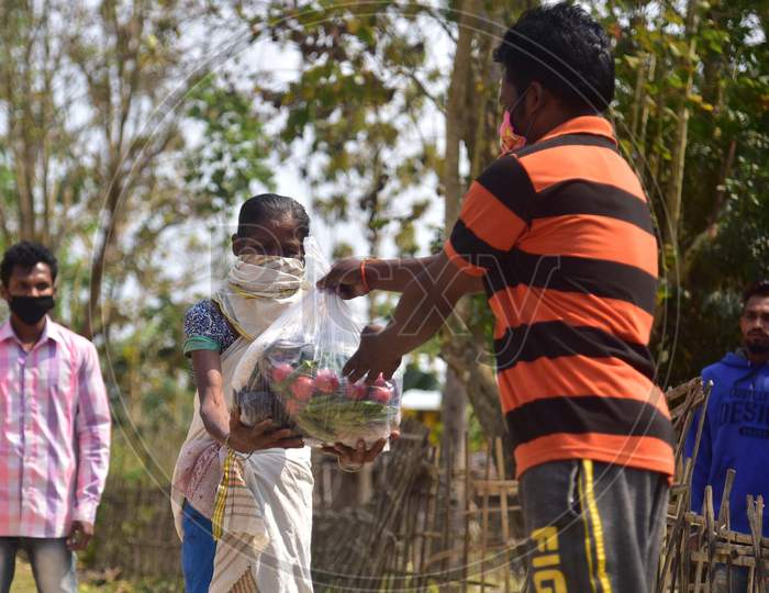 Volunteers  Distribute Ration Among Tea Tribe People During A Nationwide Lockdown Imposed In The Wake Of Coronavirus Pandemic At Samaguri In Nagaon District Of Assam