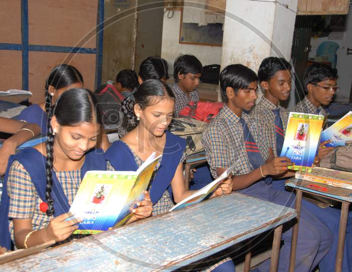 School Children With Books in Hand At a Classroom