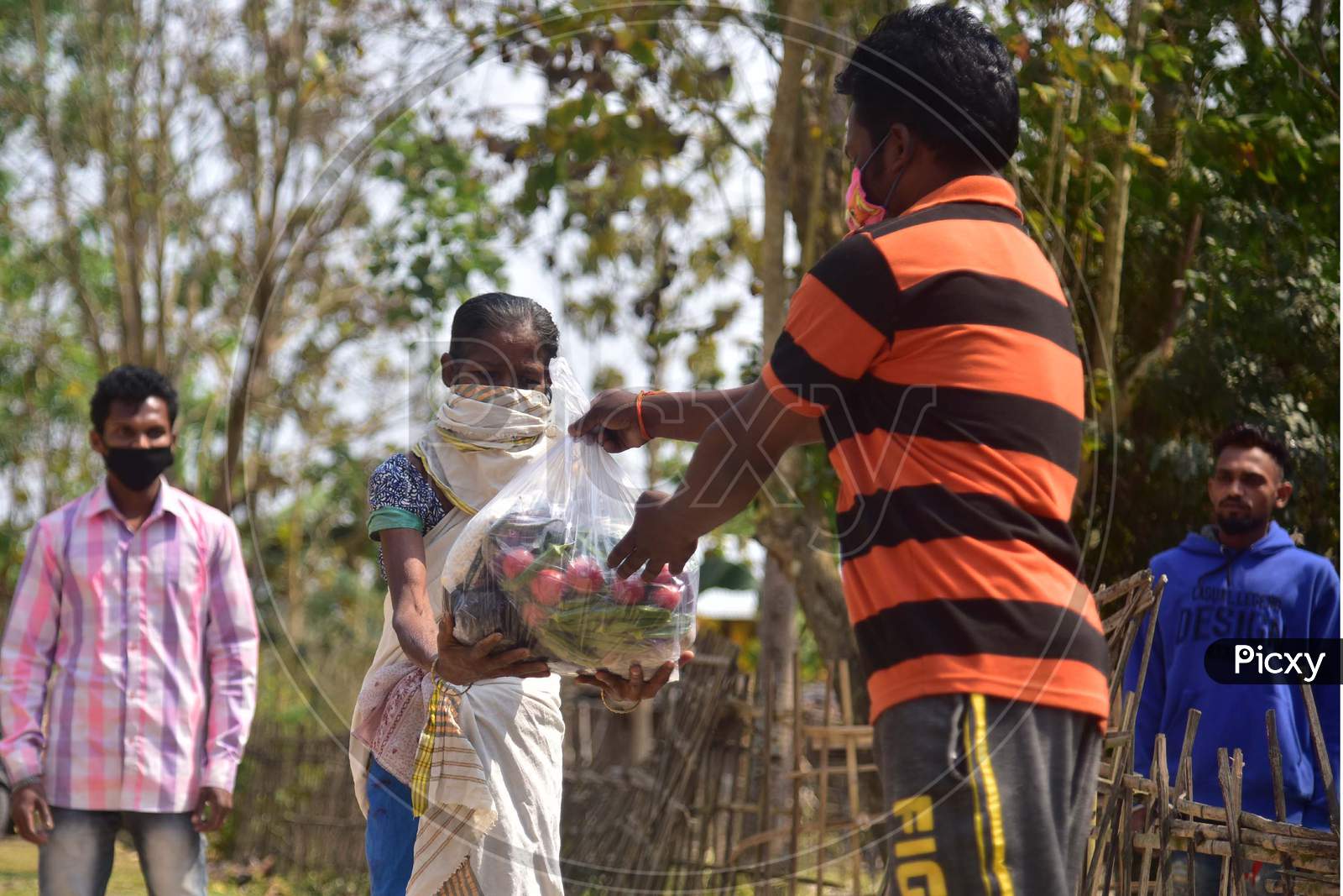 Volunteers  Distribute Ration Among Tea Tribe People During A Nationwide Lockdown Imposed In The Wake Of Coronavirus Pandemic At Samaguri In Nagaon District Of Assam