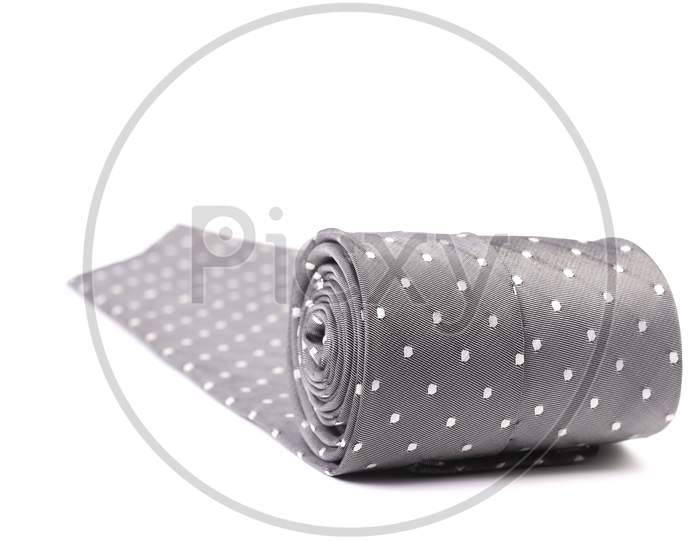 Folded Gray Tie With White Speck. Isolated On A White Background.