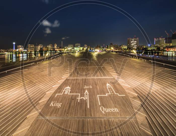 Wide Wooden Staircase In The Center Of Osanbashi Pier Where Are Inscribed The Words King Queen And Jack In The Minato Mirai District Of Yokohama With Yokohama Marine Tower In Backround.