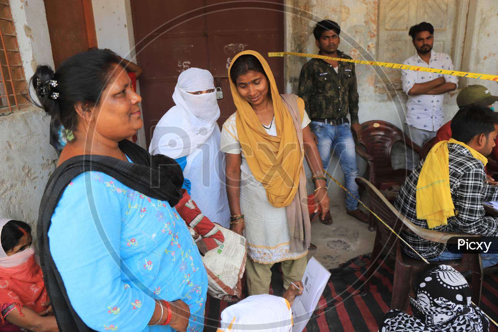 Women Waiting For Ration At A Government Ration Shop During Nationwide Lockdown In Wake Of Coronavirus Or COVID-19  Pandemic In Prayagraj, March 12, 2020.