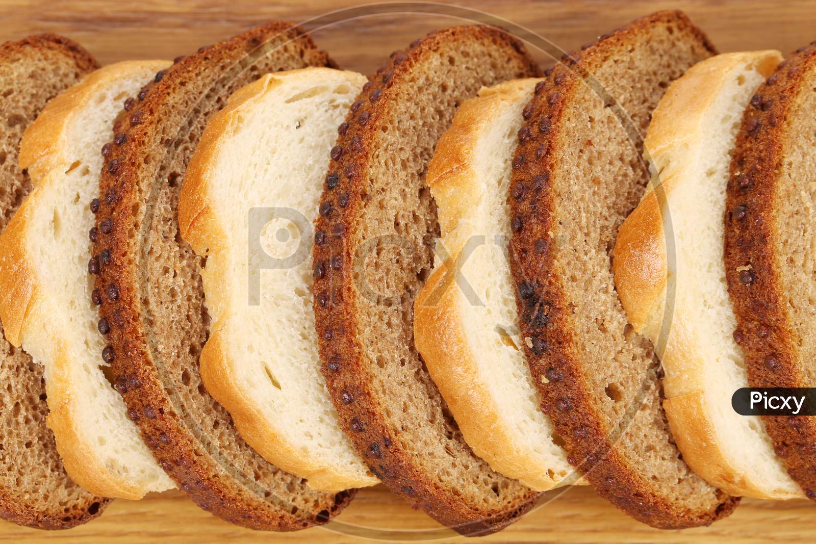 Sliced White And Brown Loaf Of Bread. Whole Background.