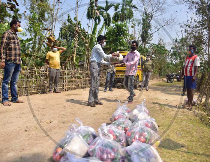 Volunteers Distributing Ration Among Tea Tribe People During A Nationwide Lockdown Imposed In The Wake Of Coronavirus Pandemic At Samaguri In Nagaon District Of Assam