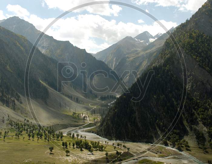 Landscape of Green Terrains And River Valleys in Ladakh With Blue Sky As Background