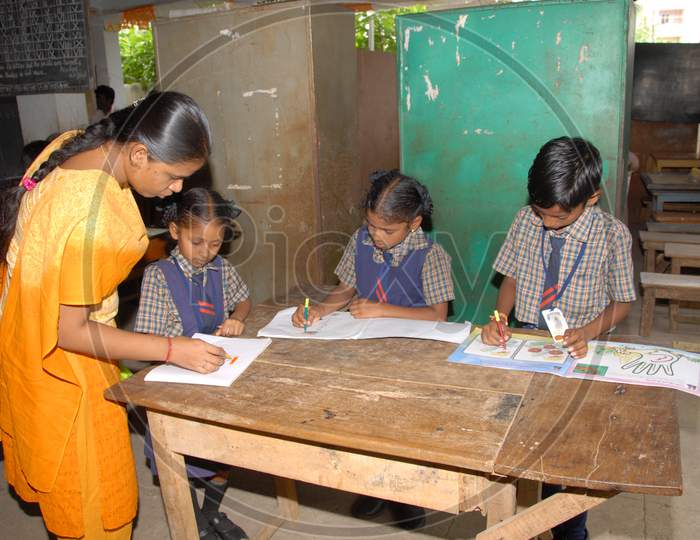 School Children Practicing  Drawing on a Painting Book in  a Classroom
