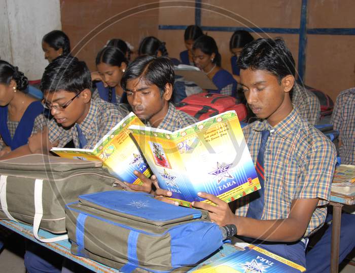 School Children With Books in Hand At a Classroom