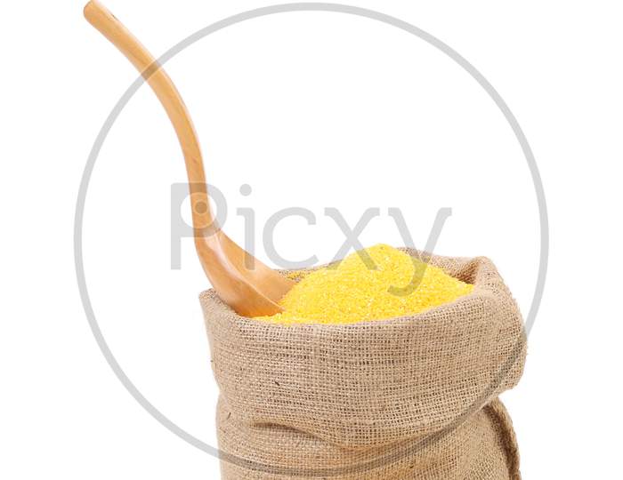 Cornmeal In Bag With Spoon. Isolated On A White Background.