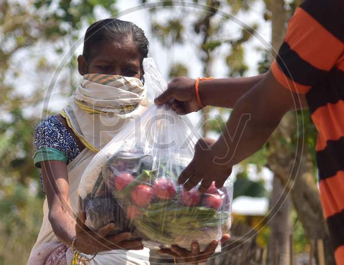Volunteers Distribute Ration Among Tea Tribe People During A Nationwide Lockdown Imposed In The Wake Of Coronavirus Pandemic At Samaguri In Nagaon District Of Assam