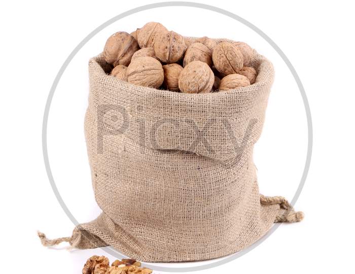 Sack Full Of Walnuts. Close Up. Isolated On A White Background.
