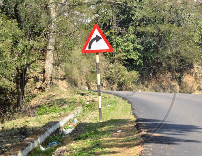 Beautiful road side view of Himachal Pradesh with right turn sign, India