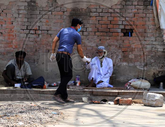 A Man Distributes Food To Homeless People During Nationwide Lockdown In Wake Of Coronavirus or COVID-19  Pandemic In Prayagraj, March 12, 2020.