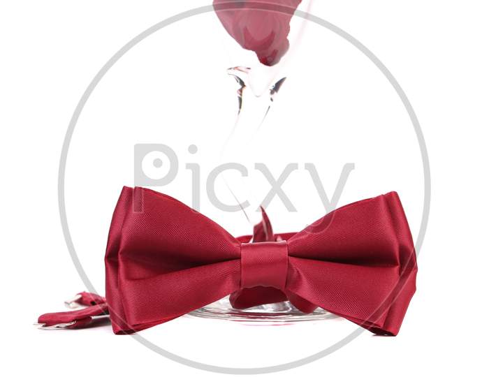 Red Bow On Champagne Glass. Isolated On A White Background.