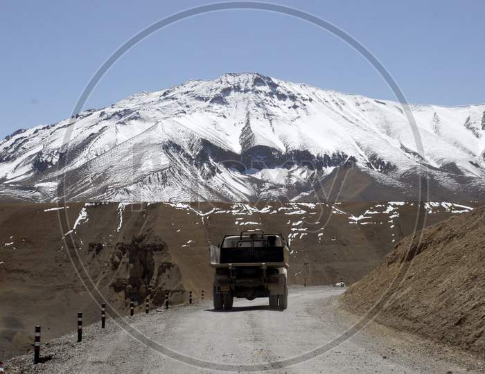 Trucks In The Roads of Ladakh With Mountains in Background