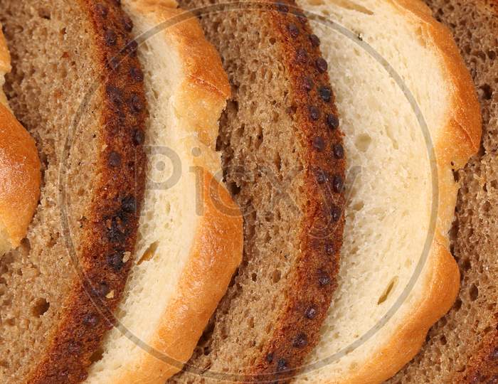 Sliced White And Brown Loaf Of Bread. Whole Background.