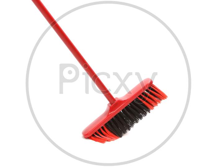 Close Up Of Red Black Broom. Isolated On A White Background.