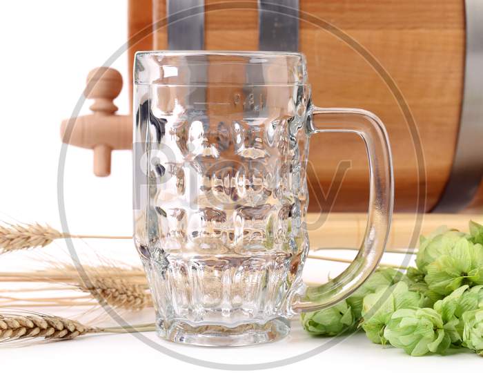 Close Up Of Beer Mug. Isolated On Barrel And Hop Background.