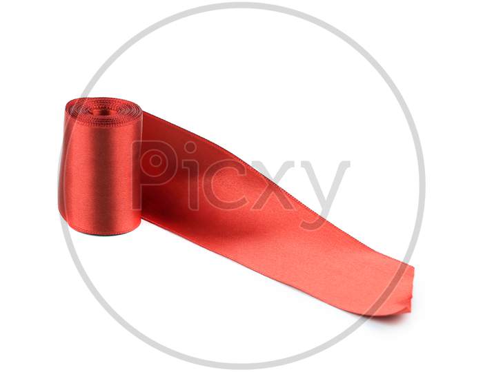 Red Silk Ribbon Roll. Isolated On A White Background.