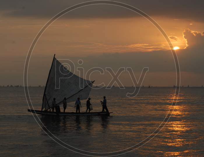 Silhouette Of Fisher Man in Fishing Boat on Sea