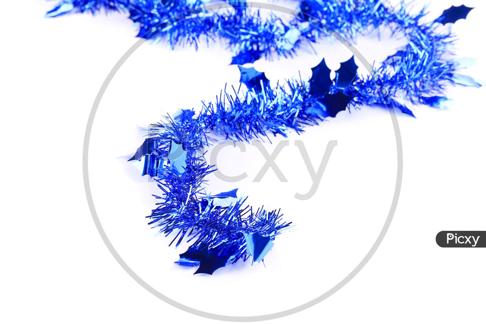 Christmas Blue Tinsel With Stars. Blurred Background.