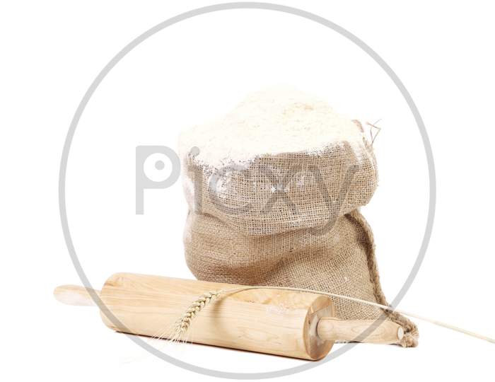 Composition Of Wheat Flour In Sack. Isolated On A White Background.