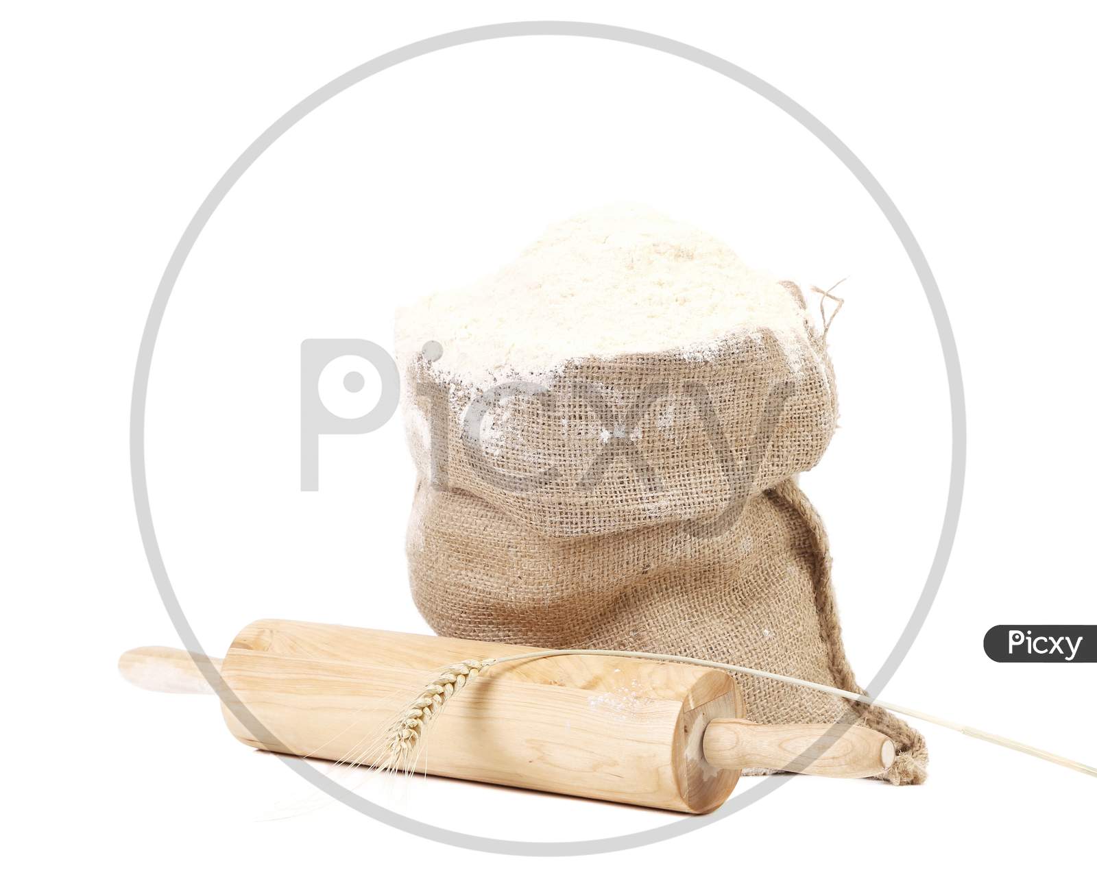 Composition Of Wheat Flour In Sack. Isolated On A White Background.