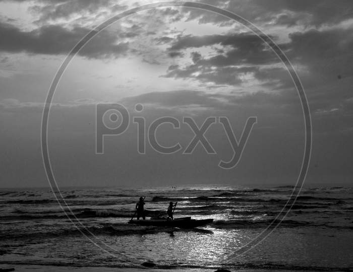 Silhouette Of fisherman On Tides Over a Sea Going For Fishing