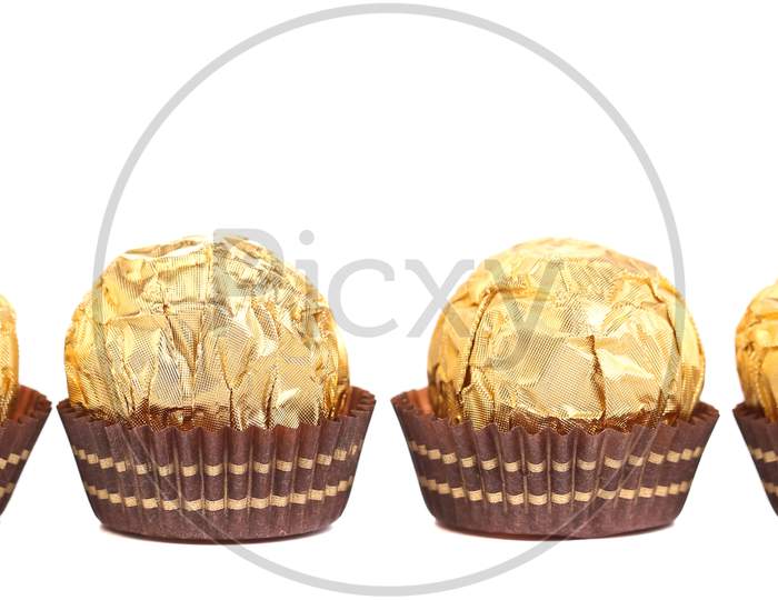 Four In Row Chocolate Bonbons. Isolated On A White Background.