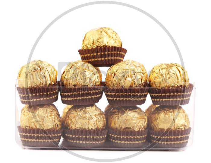 Two Rows Of Chocolate Bonbons In Box. Isolated On A White Background.