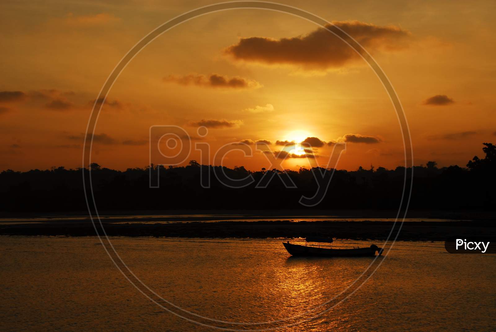 Silhouette Of a Fishing Boat Over Sunset Sky In Background
