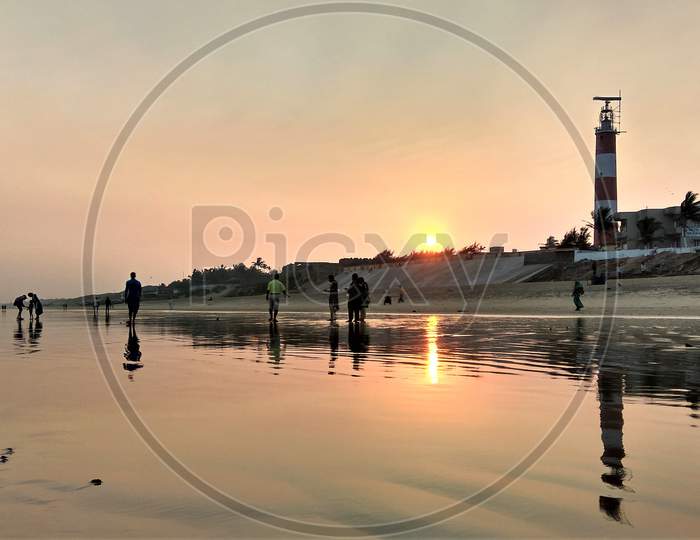 People playing at Sea Beach during sunset