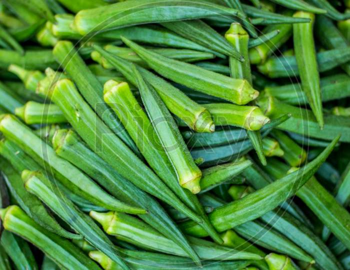Green Ladies Finger On The Vegetable Market - Okra, Abelmoschus Esculentus, Known In Many Countries As Ladies' Fingers Or Ochro. The Geographical Origin Of West African, Ethiopian & Asian Origins