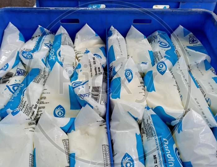 Nandini milk brand kept in crates in front of retail shop.