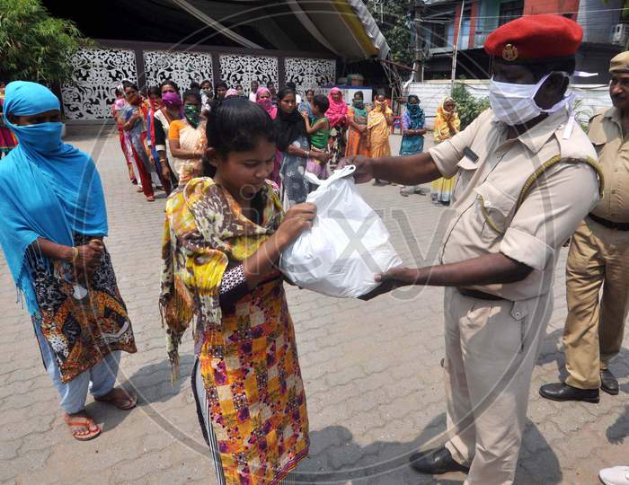 Assam Police Personnel Distributing Rice To The Poor During The Nationwide Lockdown Amid Corona Virus Or Covid-19 Pandemic In Guwahati On Tuseday, 14 April 2020.