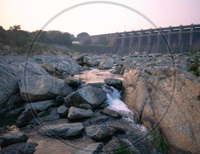 Water Flowing Between The Rocks After Using It In A Dam