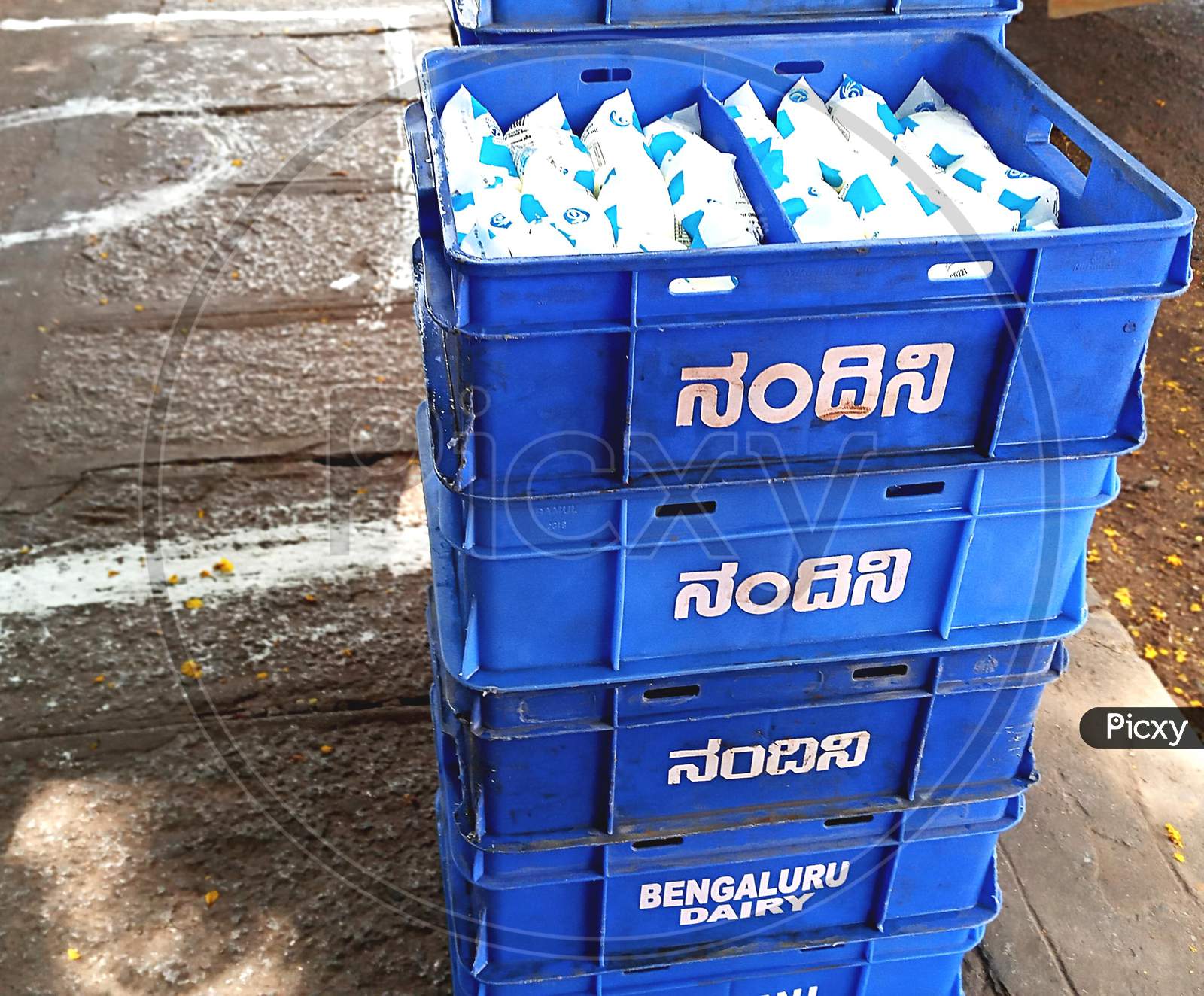 Crates of nandini milk packet kept in front of retail shop