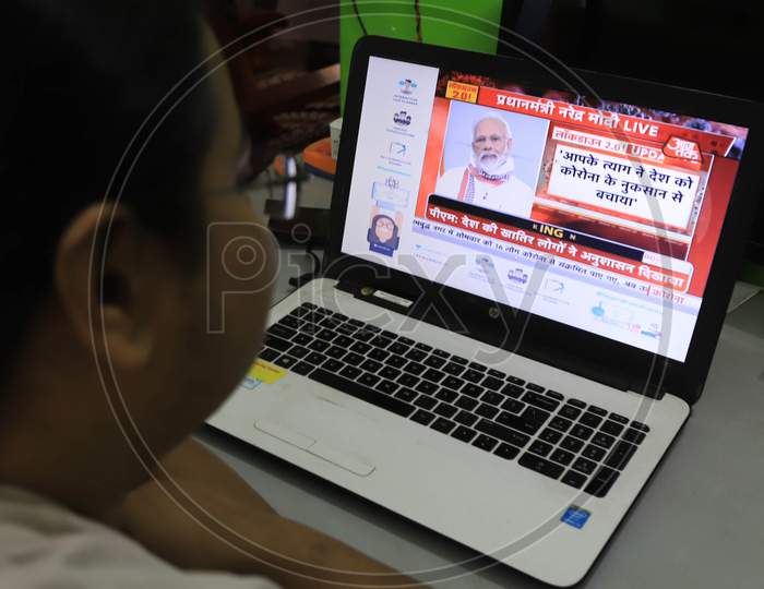 A Woman Watching Prime Minister Narendra Modi Addressing The Nation Regarding National Lockdown due to coronavirus Covid-19 outbreak In India, Prayagraj, April, 14, 2020.