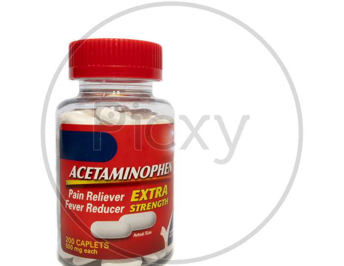 Red Acetaminophen Bottle Full Of Pills On A White Background.