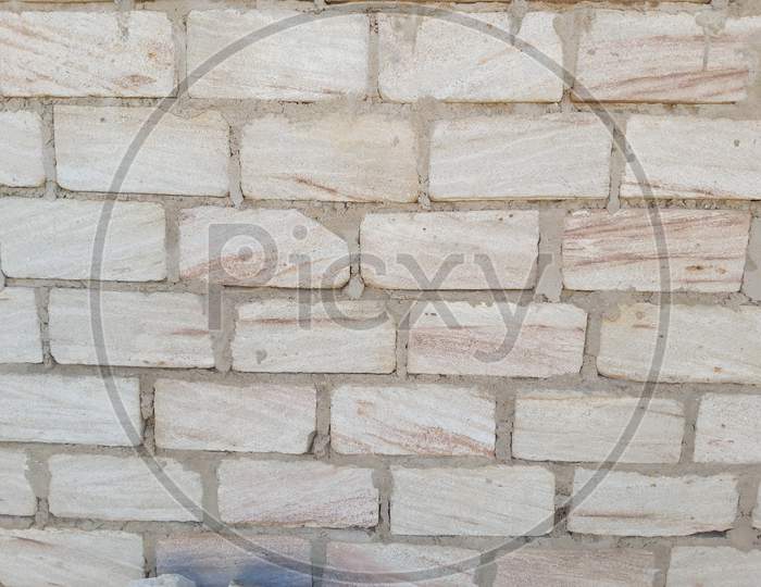 Naturally stone block fixed with Cement wall background.
