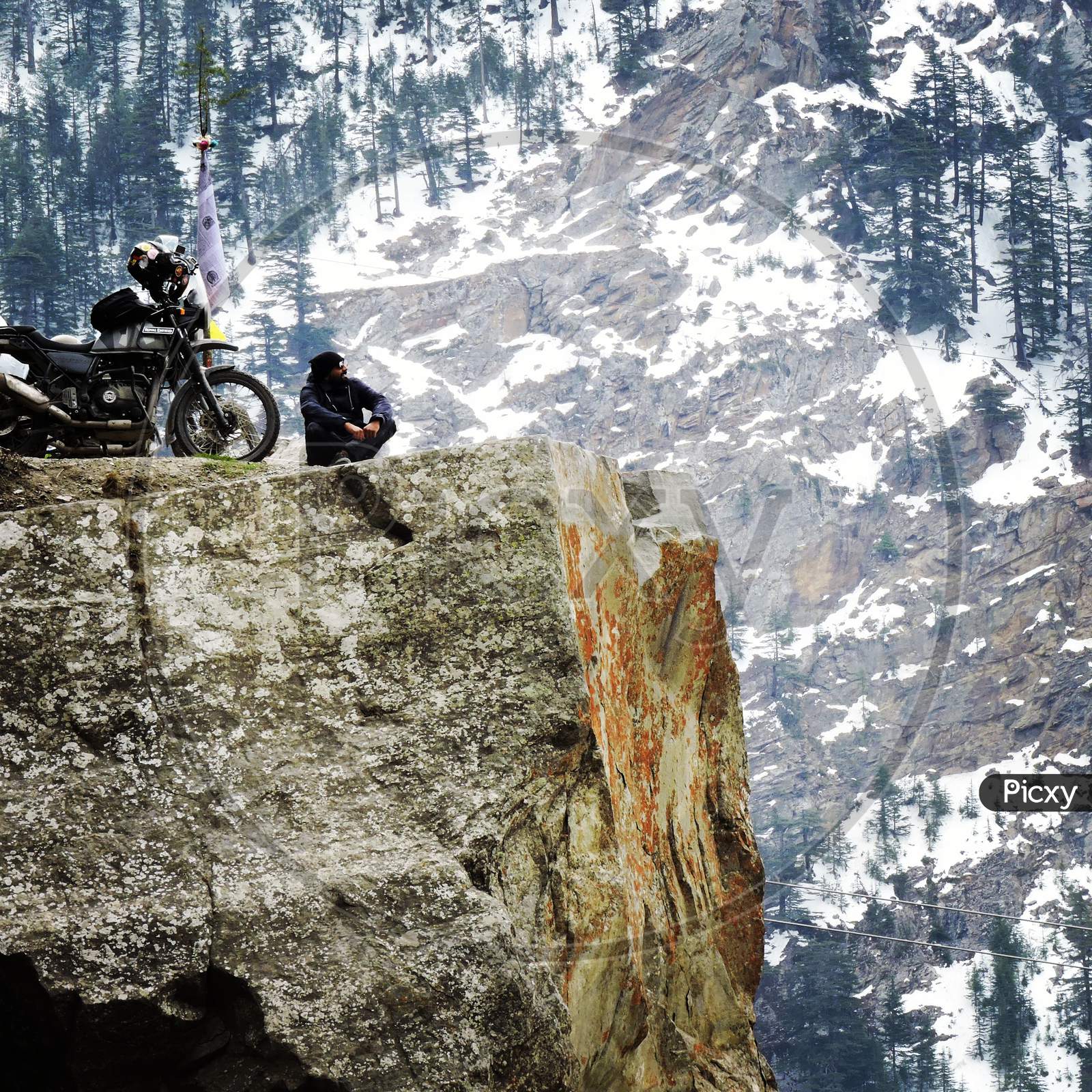 A bike rider sitting in the mountains