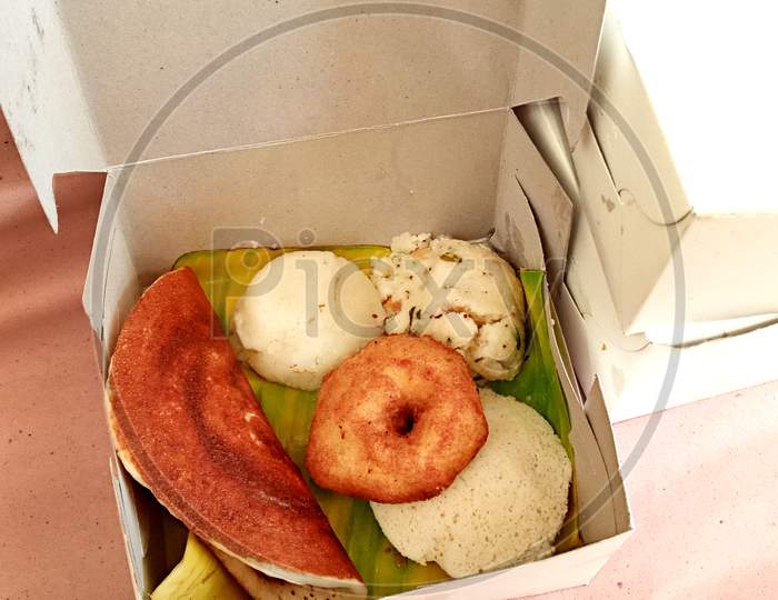 Combo south indian vegetarian  breakfast packed in a take away box in Bengaluru.