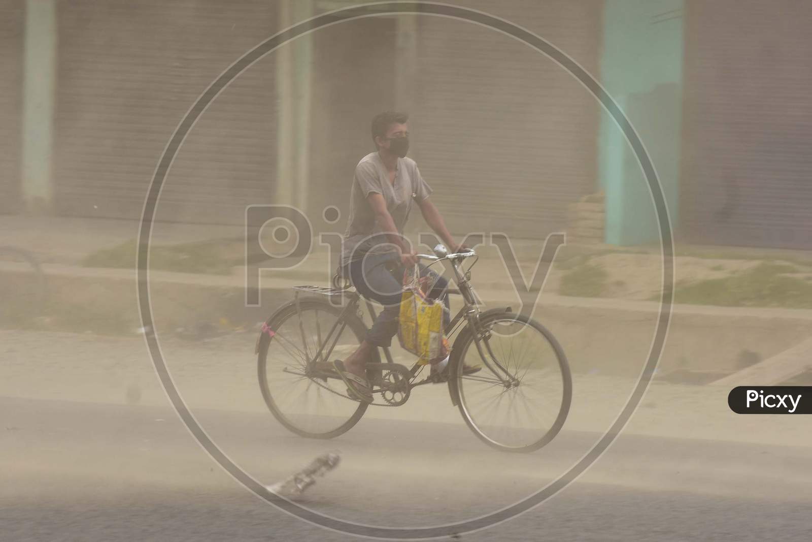 A Man Rides A Bicycle During Massive Dust Storm  During A Nationwide Lockdown In The Wake Of Corona virus or COVID-19  Pandemic, In Nagaon District Of Assam On April 15,2020.