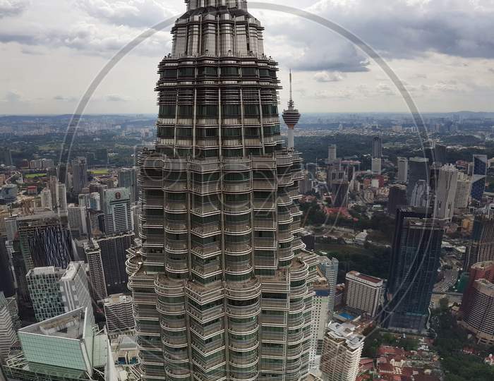 The View Of A Petronus Tower From Another Tower With Kuala Lampur City Scape Horizon In The Background.