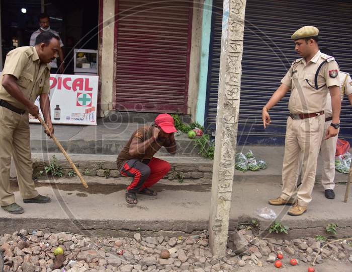 Police Officers Punish A Man  For Breaking The Lockdown Rules During A Nationwide Lockdown In The Wake Of Corona virus or COVID-19  Pandemic, In  Nagaon District Of Assam On April 15,2020.