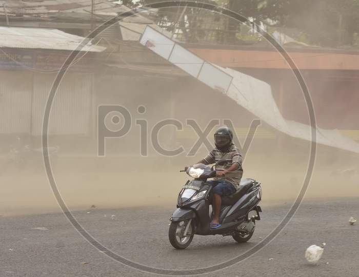 A Man Rides A Bike During Massive Dust Storm  During A Nationwide Lockdown In The Wake Of Corona virus or COVID-19 Pandemic, In  Nagaon District Of Assam On April 15,2020.