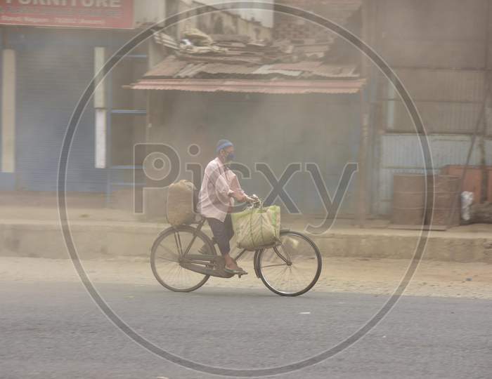 A Man Rides A Bicycle During Massive Dust Storm During A Nationwide Lockdown In The Wake Of Corona virus or COVID-19  Pandemic, In Nagaon District Of Assam On April 15,2020.