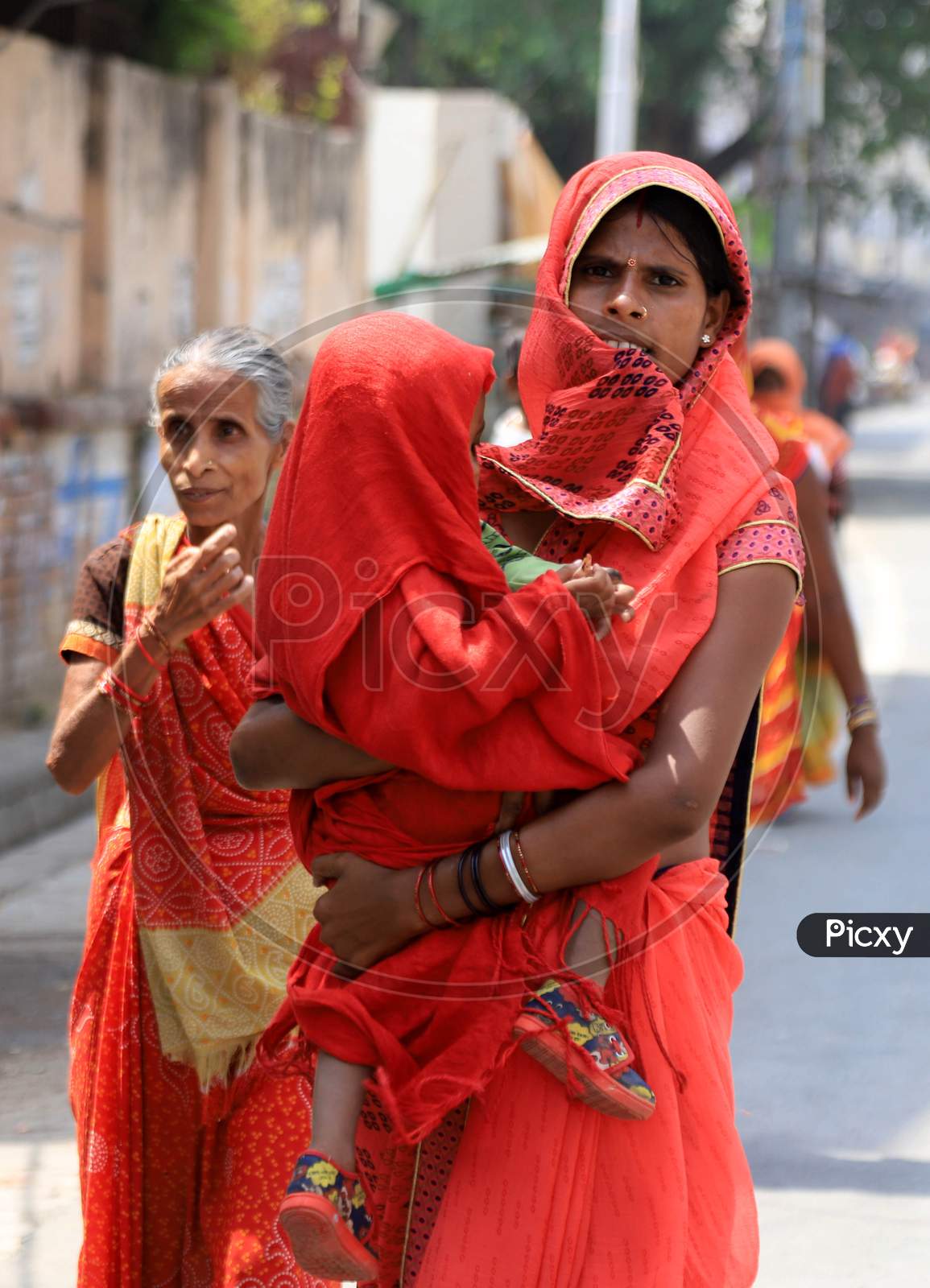 A Woman With Her Child Outside Of A Bank To Withdraw Money During A Nationwide Lockdown To Slow The Spreading Of The Coronavirus Disease (Covid-19), In Prayagraj, April, 15, 2020.