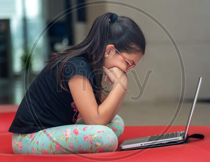 a kid studying in laptop amid corona virus lockdown. 