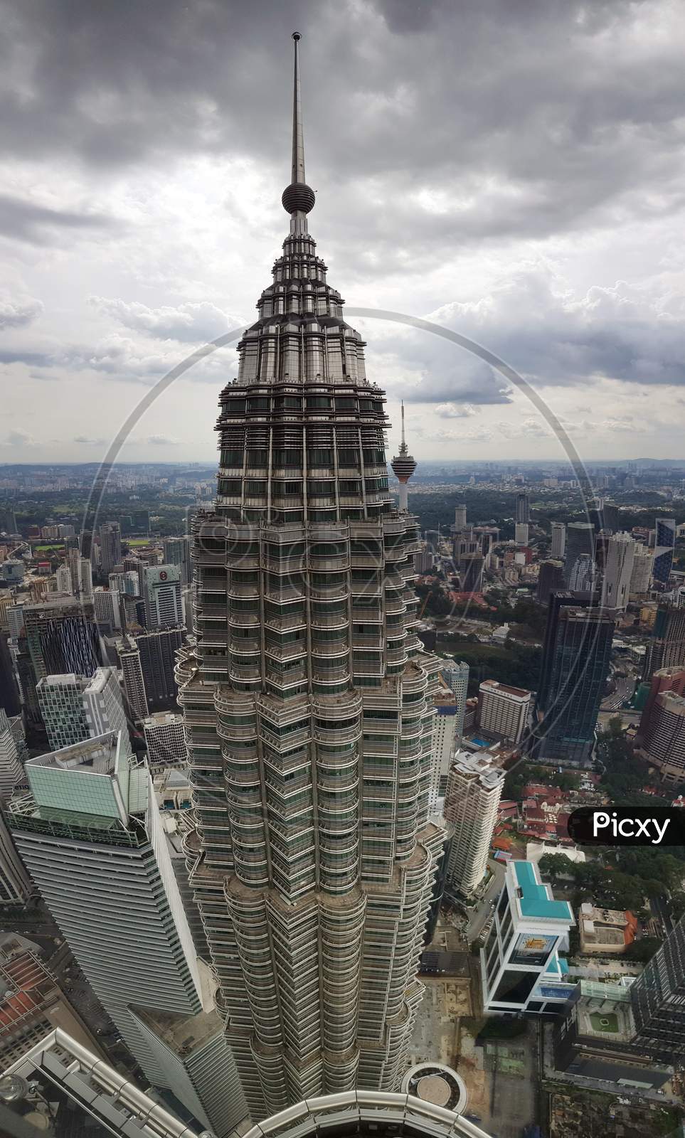 The View Of A Petronus Tower From Another Tower With Kuala Lampur City Scape Horizon In The Background.