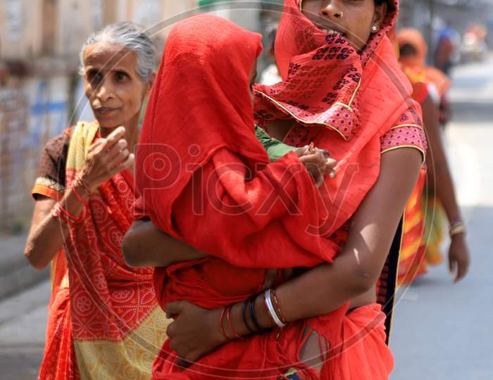 A Woman With Her Child Outside Of A Bank To Withdraw Money During A Nationwide Lockdown To Slow The Spreading Of The Coronavirus Disease (Covid-19), In Prayagraj, April, 15, 2020.